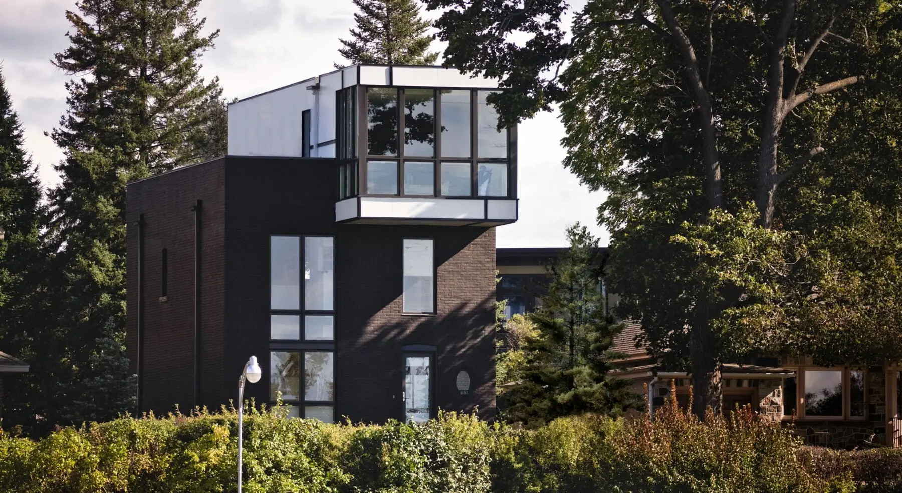Exterior view of Echo House from distance surrounded by trees